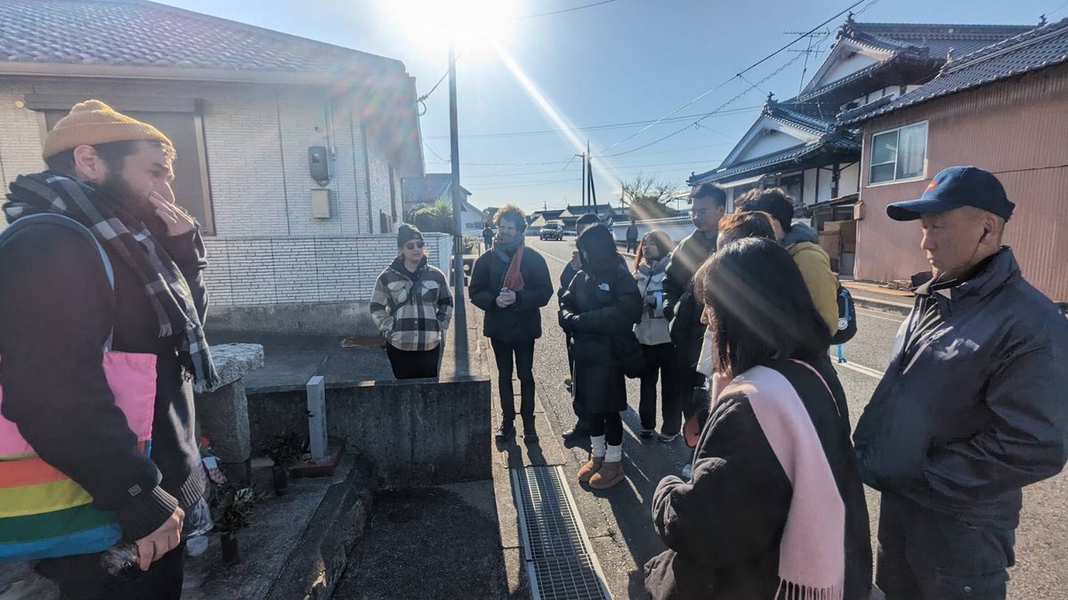 A studio cohort walking the island's vacant houses with a resident.